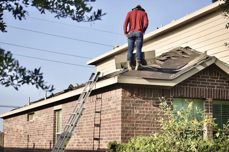 Professional roofer working on a residential roof in Anamosa